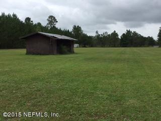 8236 Brooks Road Bryceville, FL 32009 - Photo 4 of 26 a view of a barn in the middle of a field
