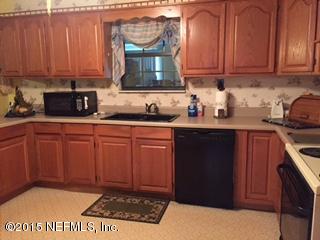 8236 Brooks Road Bryceville, FL 32009 - Photo 8 of 26 a kitchen with stainless steel appliances granite countertop a sink stove and cabinets