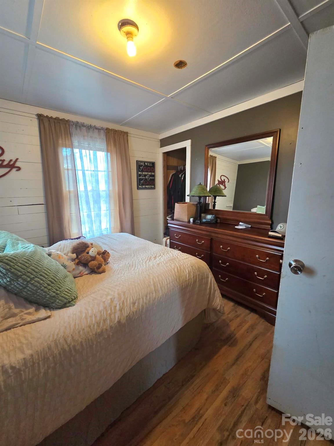 8772 Honeycutt Road Stanfield, NC 28163 - Photo 3 of 7 a bedroom with a bed and wooden floor