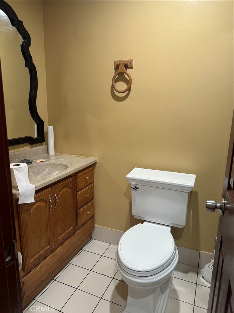 7721 Rhea Avenue Reseda, CA 91335 - Photo 4 of 16 a bathroom with a toilet sink and mirror