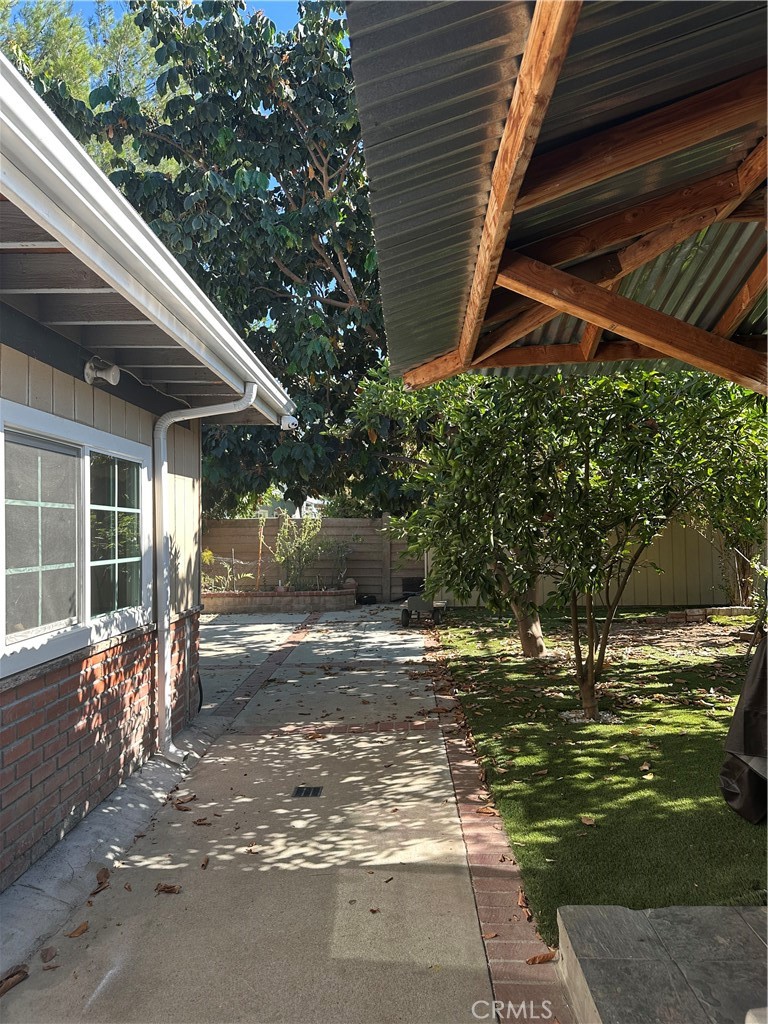 7721 Rhea Avenue Reseda, CA 91335 - Photo 8 of 16 a view of a backyard with table and chairs and potted plants