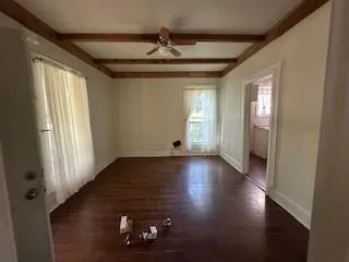 wooden floor in an empty room with a window