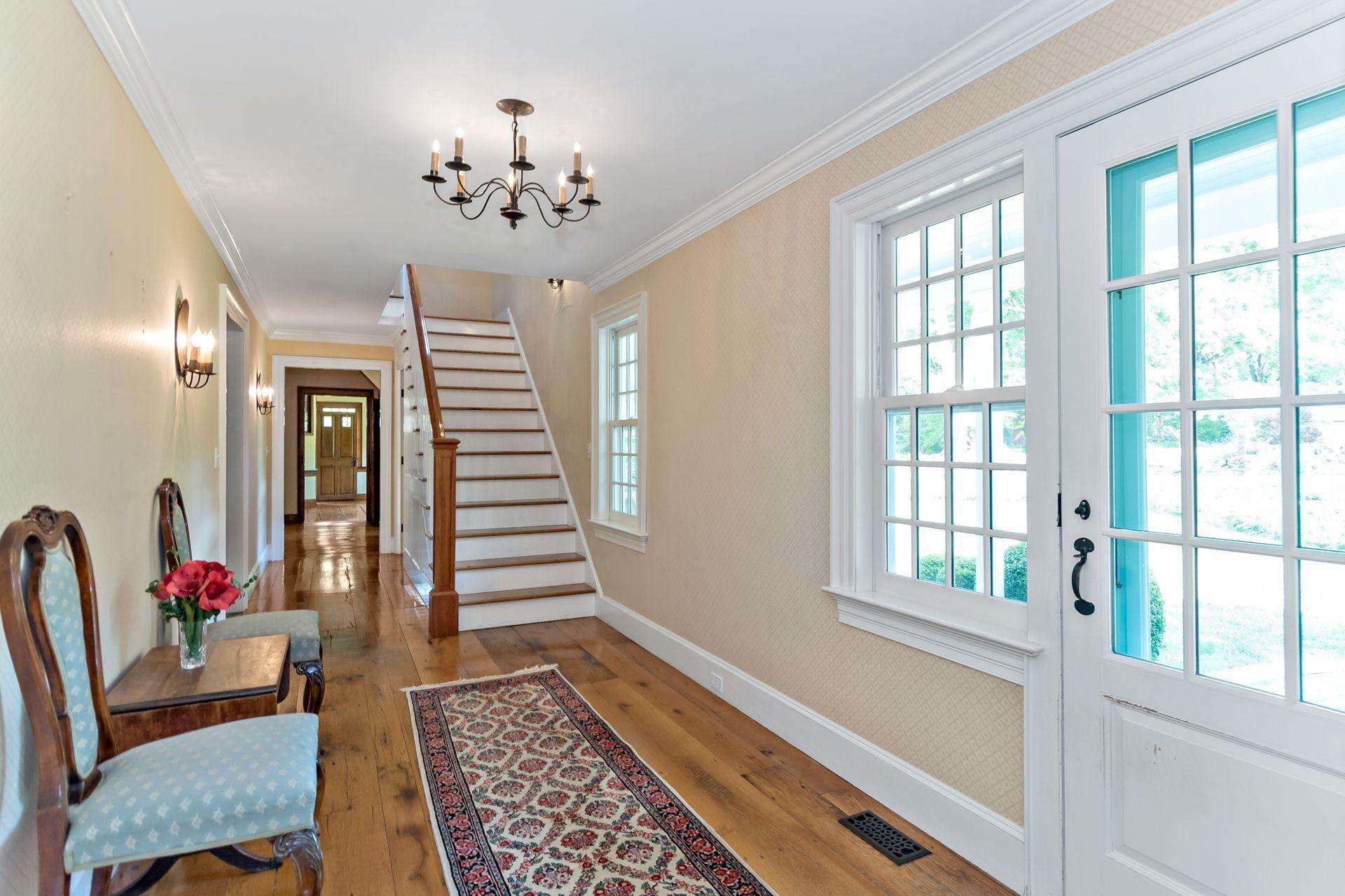 19 Tudor Road Redding, CT 06896 - Photo 27 of 55 a living room with furniture and a chandelier