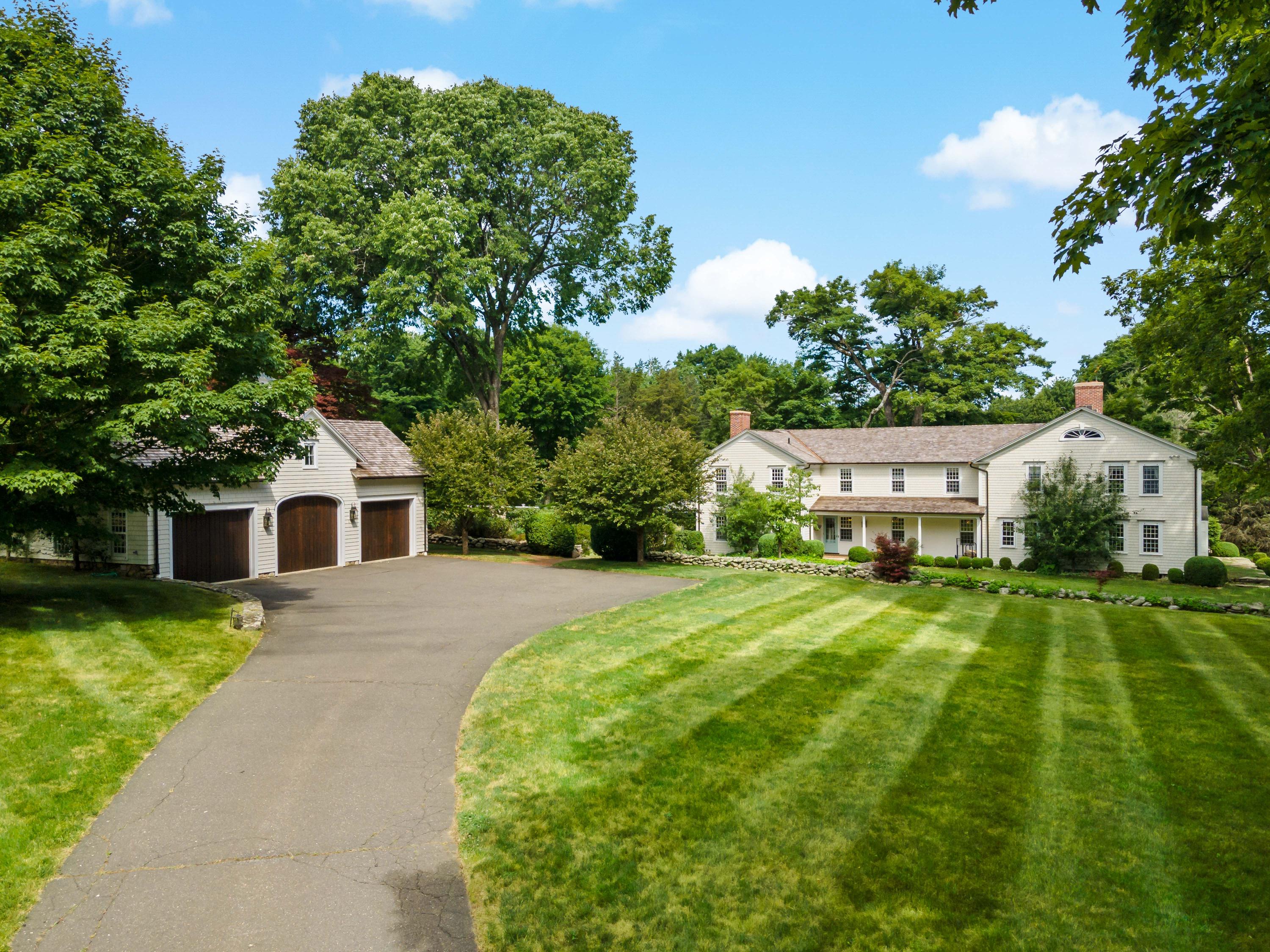 19 Tudor Road Redding, CT 06896 - Photo 54 of 55 a front view of a house with a yard