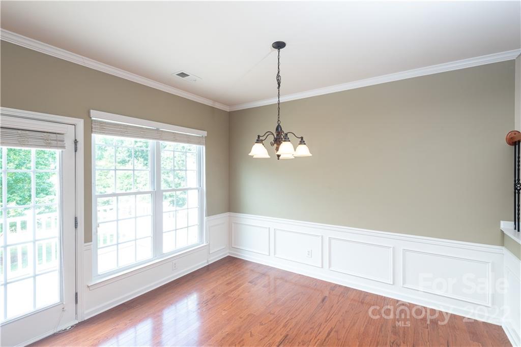 662 6th Baxter Crossing Fort Mill, SC 29708 - Photo 8 of 23 a view of an empty room with a window and wooden floor