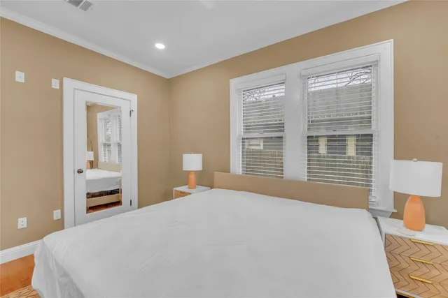 a bedroom with a large bed and a window