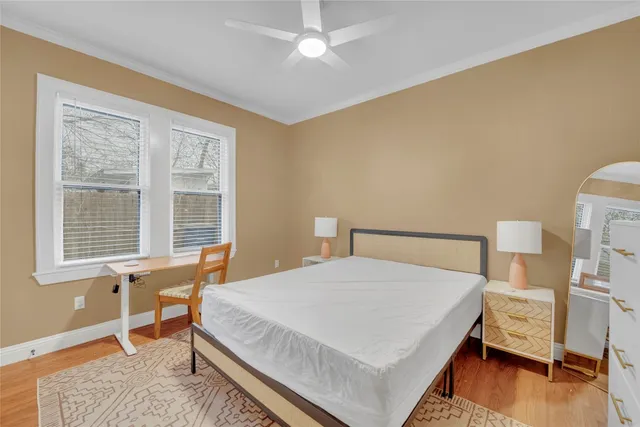 a bedroom with a bed and wooden floor