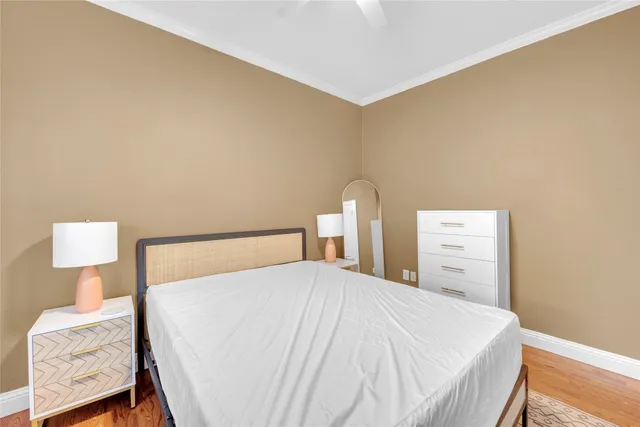 a bedroom with a bed and a lamp on dresser