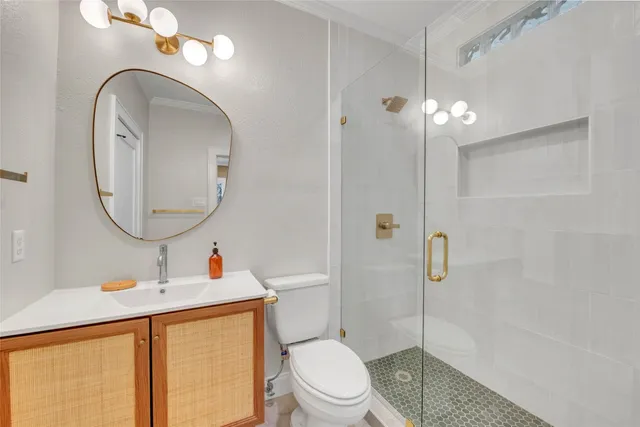 a bathroom with a toilet a sink and mirror