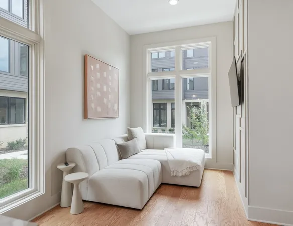 a bedroom with a bed and a couch next to a window