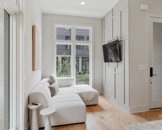 a bedroom with furniture and a flat screen tv