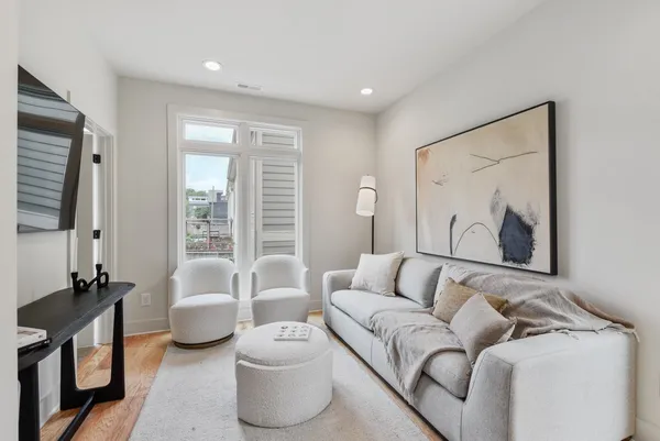 a living room with furniture and a large window