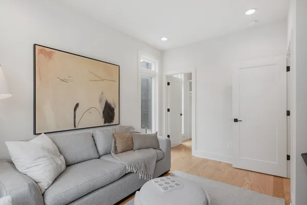a living room with furniture and a wooden floor