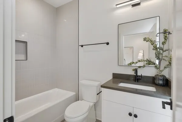 a bathroom with a sink a toilet and a mirror