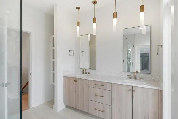 a bathroom with a double vanity sink and a mirror