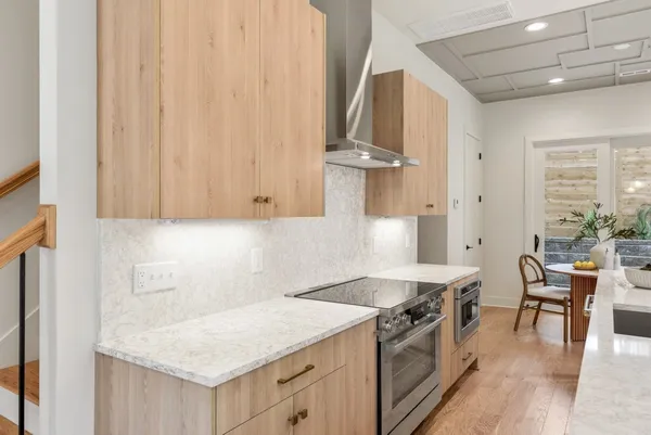 a kitchen that has a sink a stove and a table in it