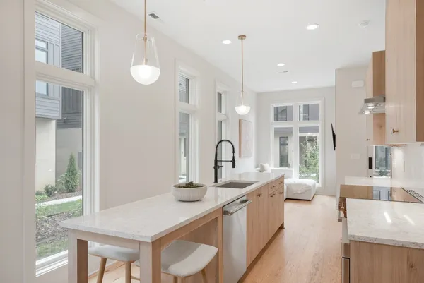 a large white kitchen with a large window