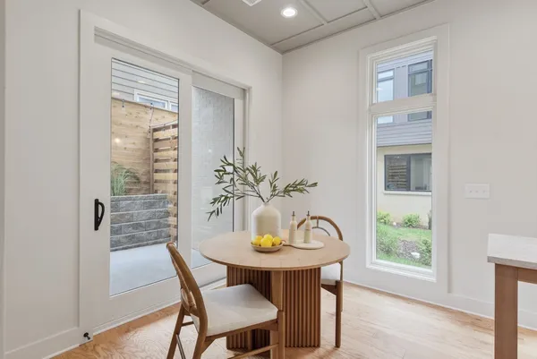 a view of a dining room with furniture window and wooden floor