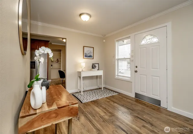 a view of a room with wooden floor and furniture
