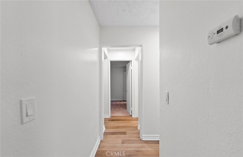 600 West 3rd Street, Unit 107 Santa Ana, CA 92701 - Photo 16 of 26 a view of a hallway with wooden staircase