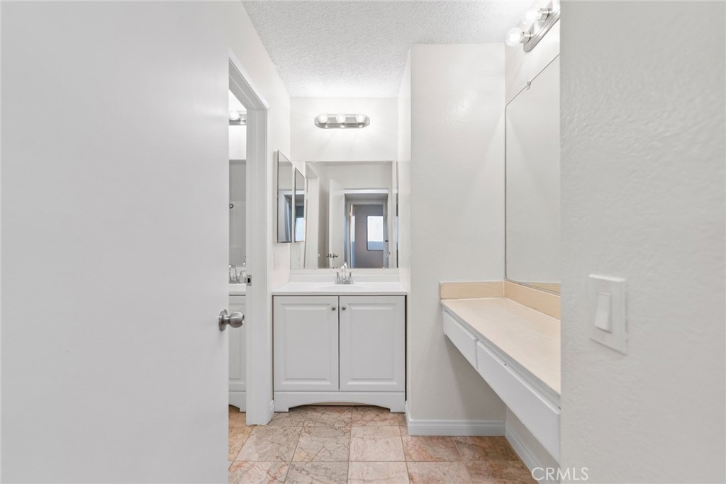 600 West 3rd Street, Unit 107 Santa Ana, CA 92701 - Photo 9 of 26 a bathroom with a sink a toilet and mirror