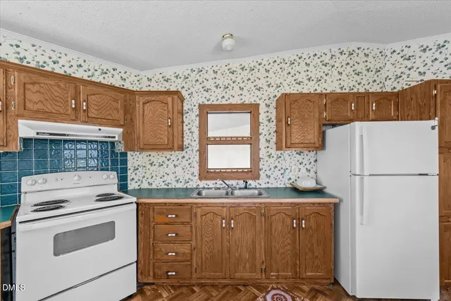 a sink and a refrigerator sitting in a kitchen