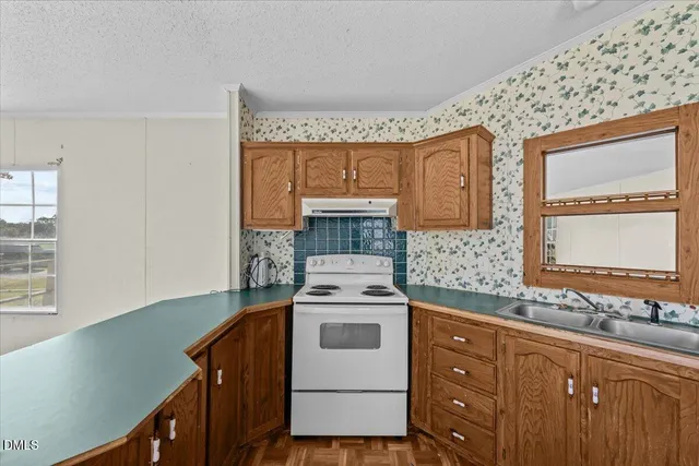 a kitchen with a stove window and cabinets
