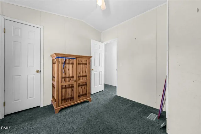 a view of an empty room with closet area
