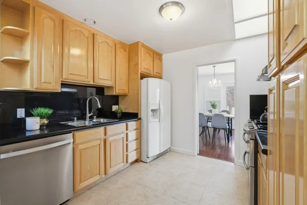 a kitchen with stainless steel appliances a refrigerator sink and cabinets