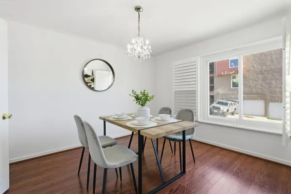 a view of a dining room with furniture window and wooden floor