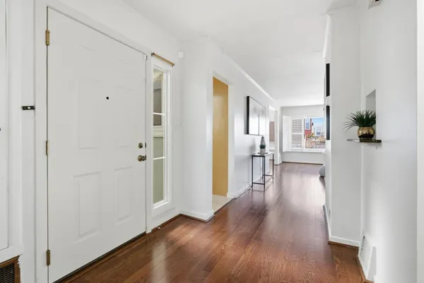 a view of a living room with hardwood floor