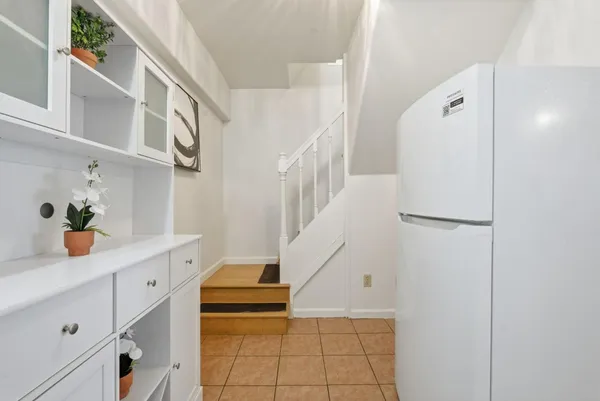 a hallway with cabinets and wooden floor
