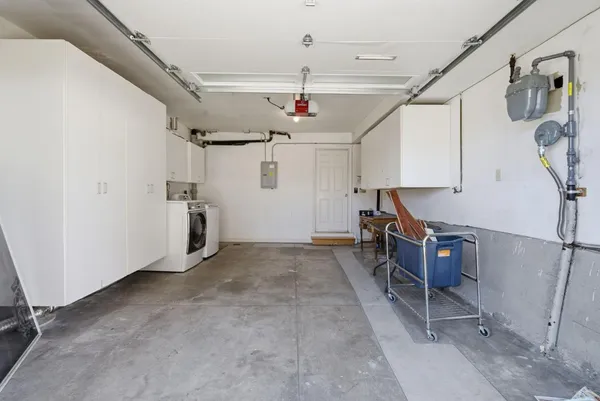 a kitchen with stainless steel appliances kitchen island a refrigerator sink and cabinets