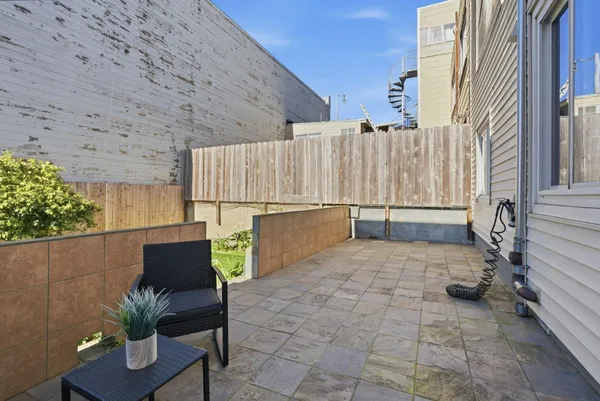 a backyard of a house with table and chairs