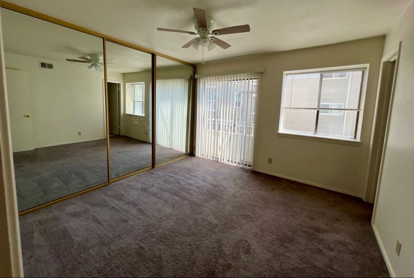 3115 Helms Street, Unit 111 Austin, TX 78705 - Photo 6 of 13 Ample mirrored closet doors create an expanded sense of space in this comfortable sleeping area.