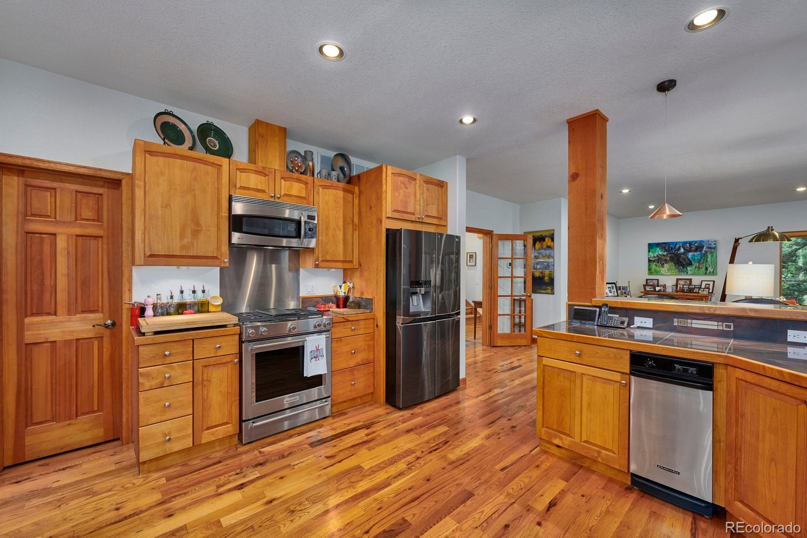 3589 Ridge Road Nederland, CO 80466 - Photo 14 of 40 a kitchen with stainless steel appliances granite countertop a stove and refrigerator