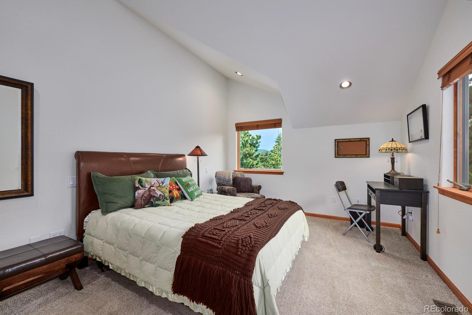 3589 Ridge Road Nederland, CO 80466 - Photo 18 of 40 a bedroom with a bed a desk and chair