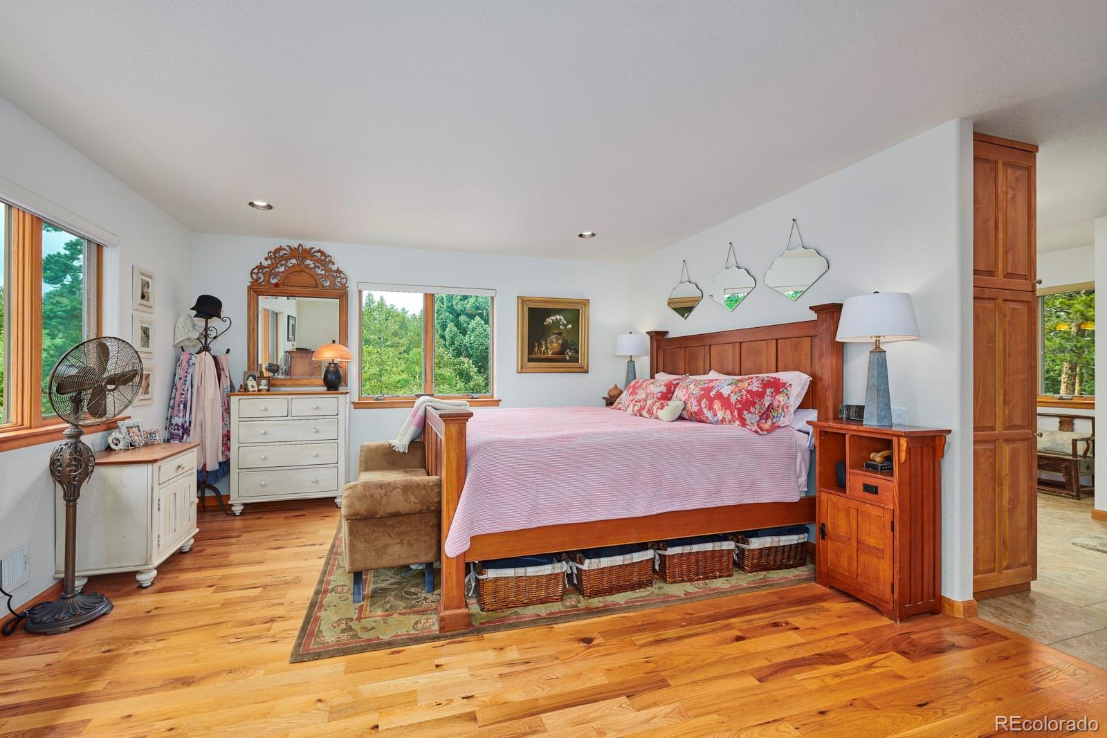 3589 Ridge Road Nederland, CO 80466 - Photo 21 of 40 a bedroom with a bed and wooden floor