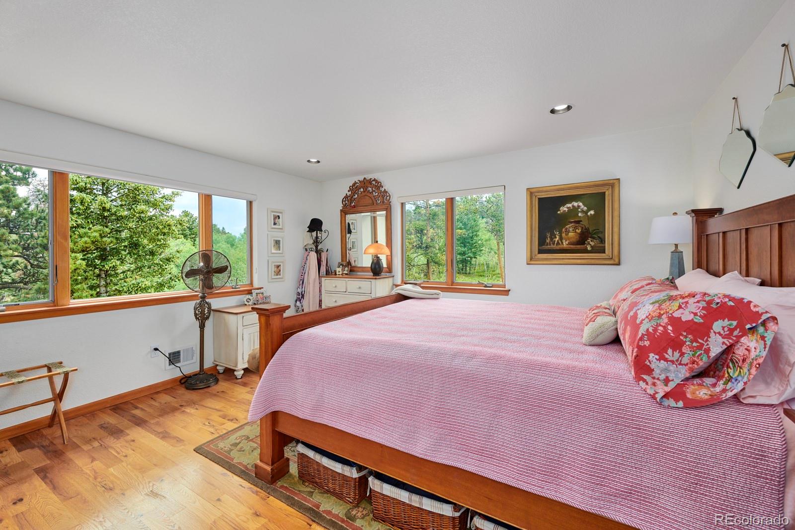 3589 Ridge Road Nederland, CO 80466 - Photo 22 of 40 a bedroom with a bed and large windows