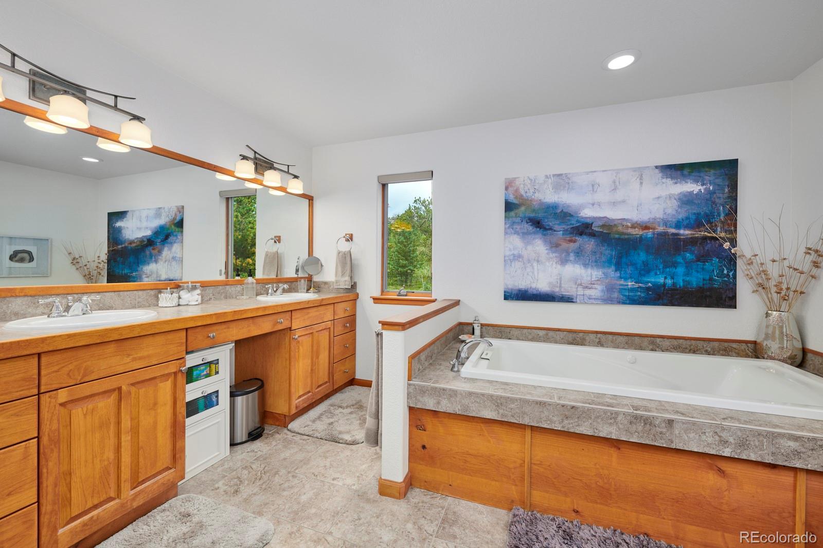3589 Ridge Road Nederland, CO 80466 - Photo 23 of 40 a spacious bathroom with a sink a large mirror and a bathtub