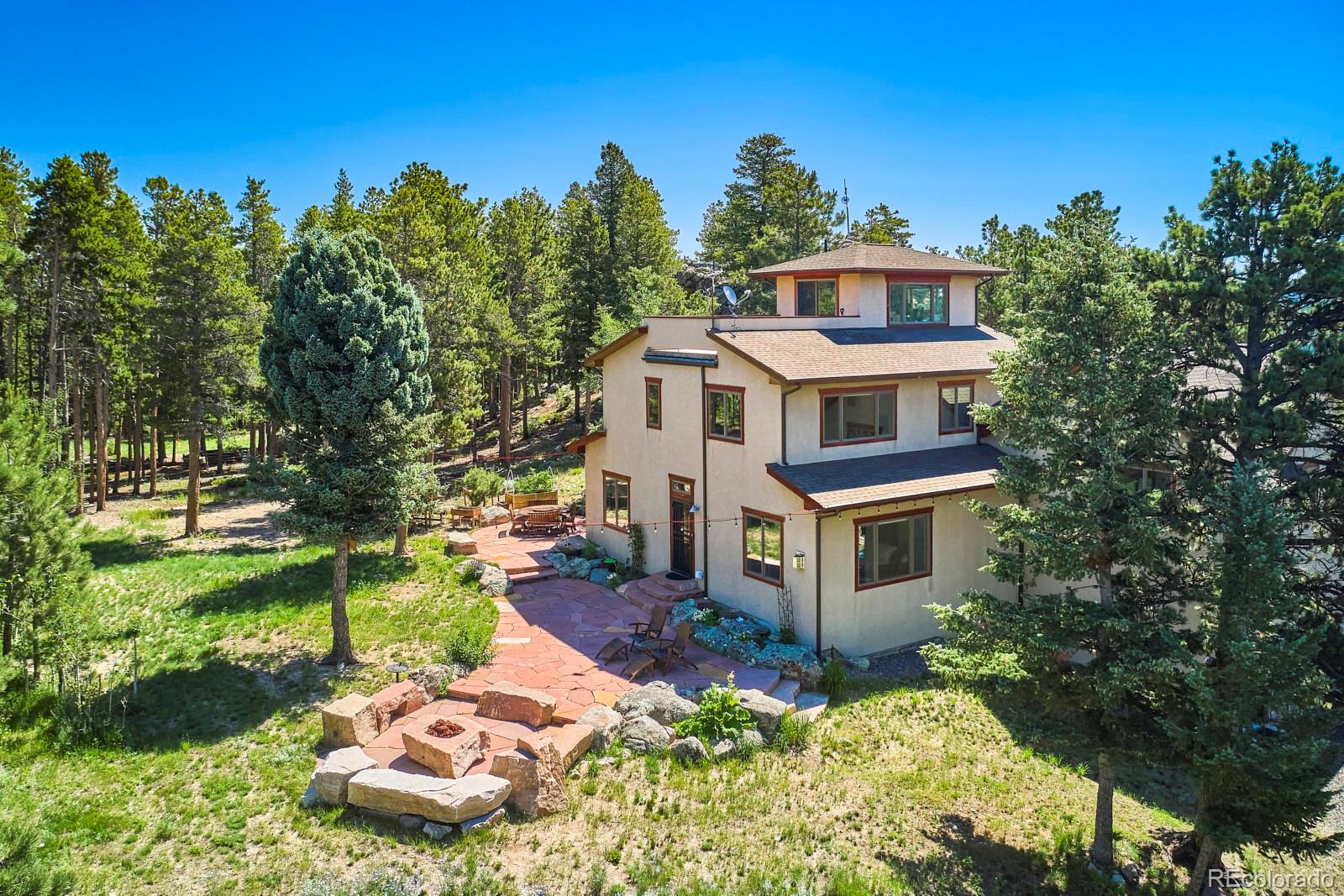 3589 Ridge Road Nederland, CO 80466 - Photo 29 of 40 a front view of a house with a yard