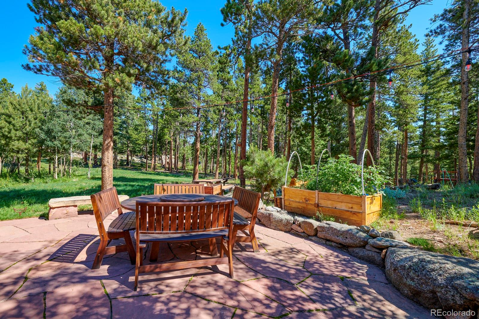 3589 Ridge Road Nederland, CO 80466 - Photo 31 of 40 a patio with water view fountain and a yard