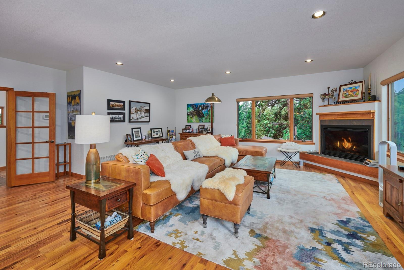3589 Ridge Road Nederland, CO 80466 - Photo 8 of 40 a living room with furniture fireplace and a large window