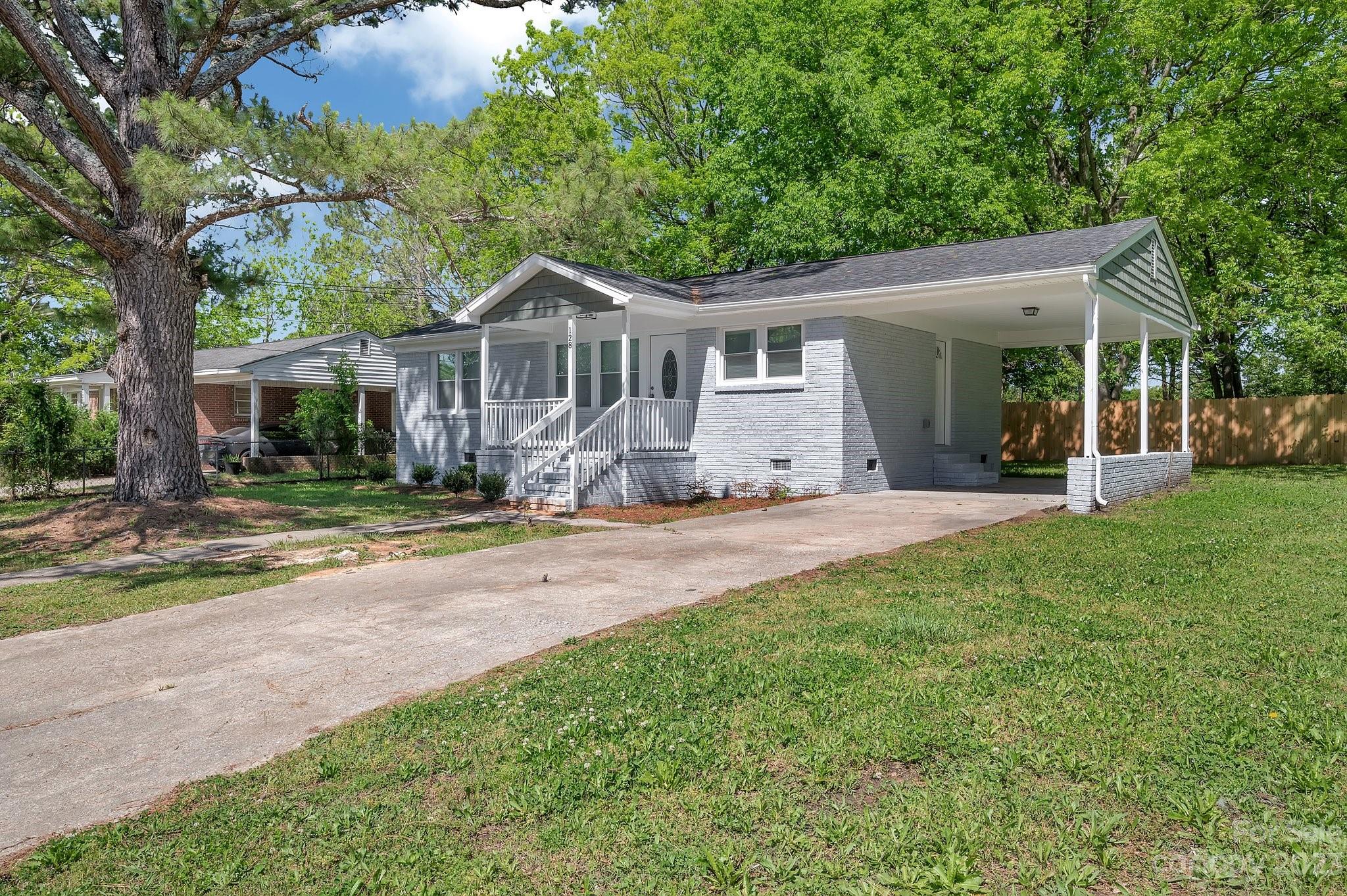 128 Jeter Street Chester, SC 29706 - Photo 1 of 20 a front view of a house with a yard porch and outdoor seating