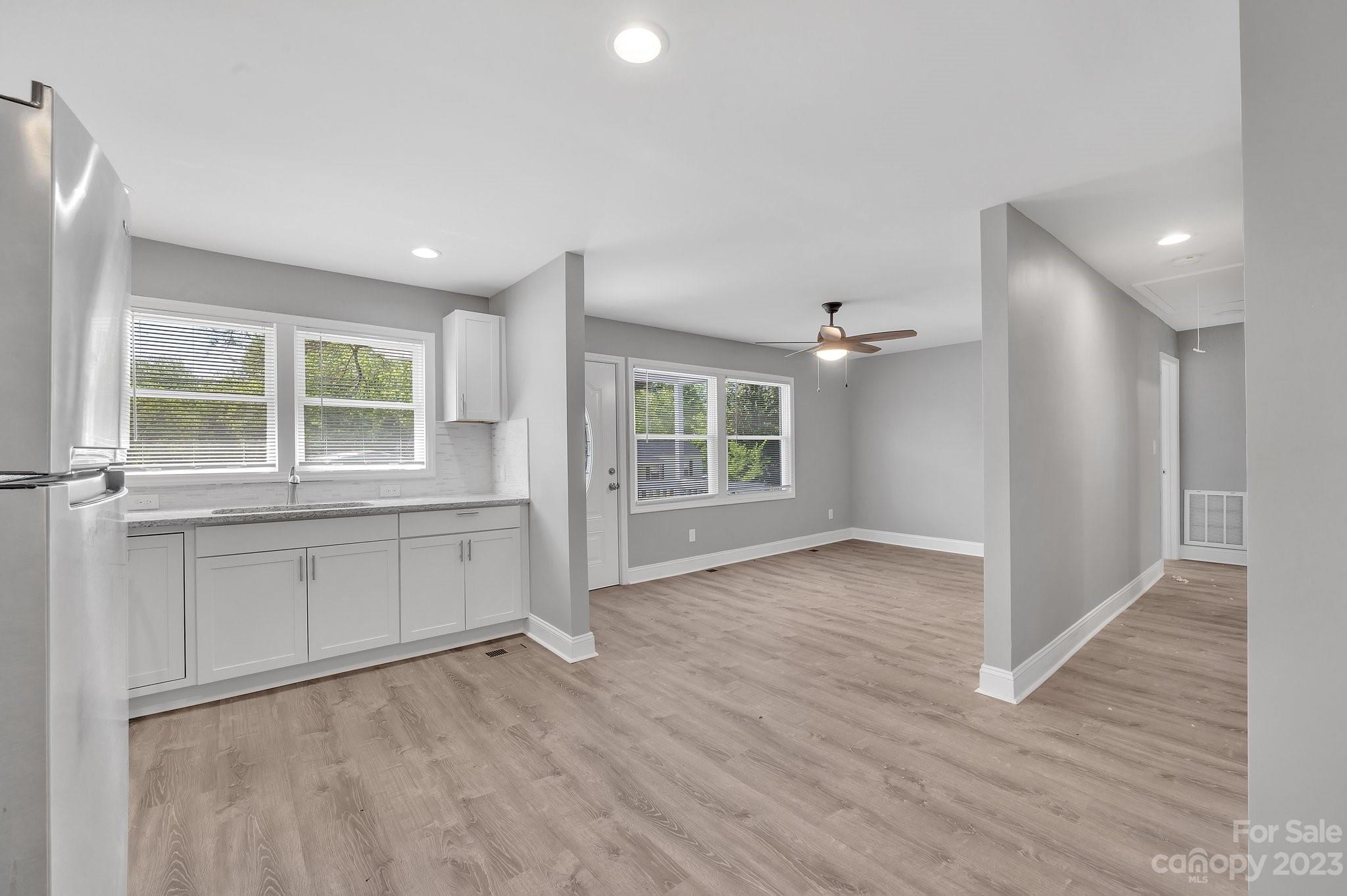 128 Jeter Street Chester, SC 29706 - Photo 19 of 20 an empty room with wooden floor and windows