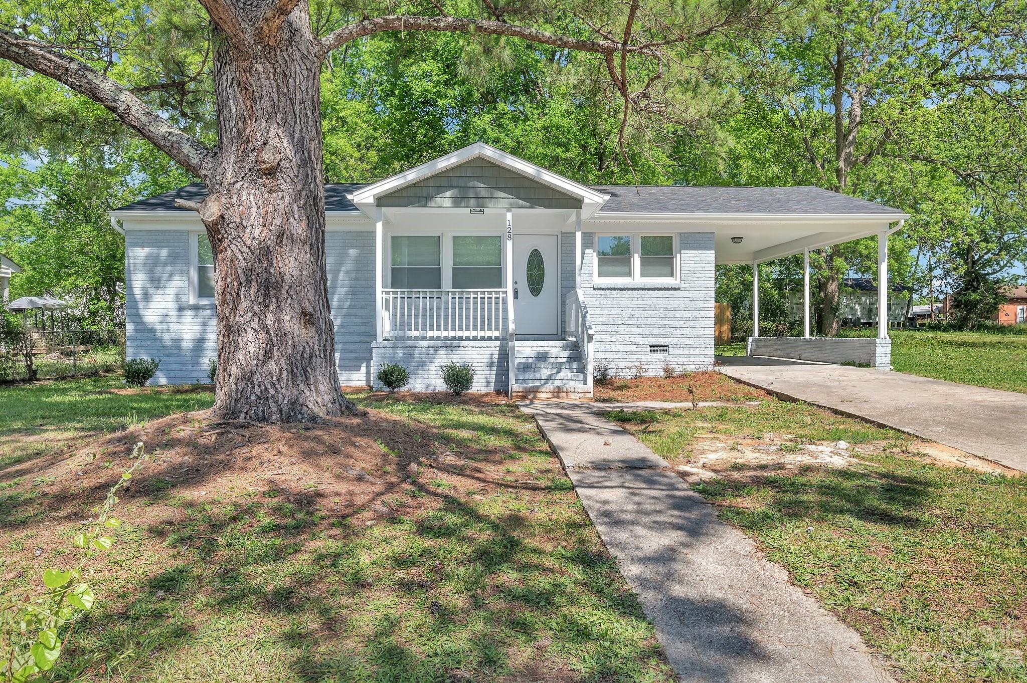 128 Jeter Street Chester, SC 29706 - Photo 2 of 20 a front view of a house with a yard