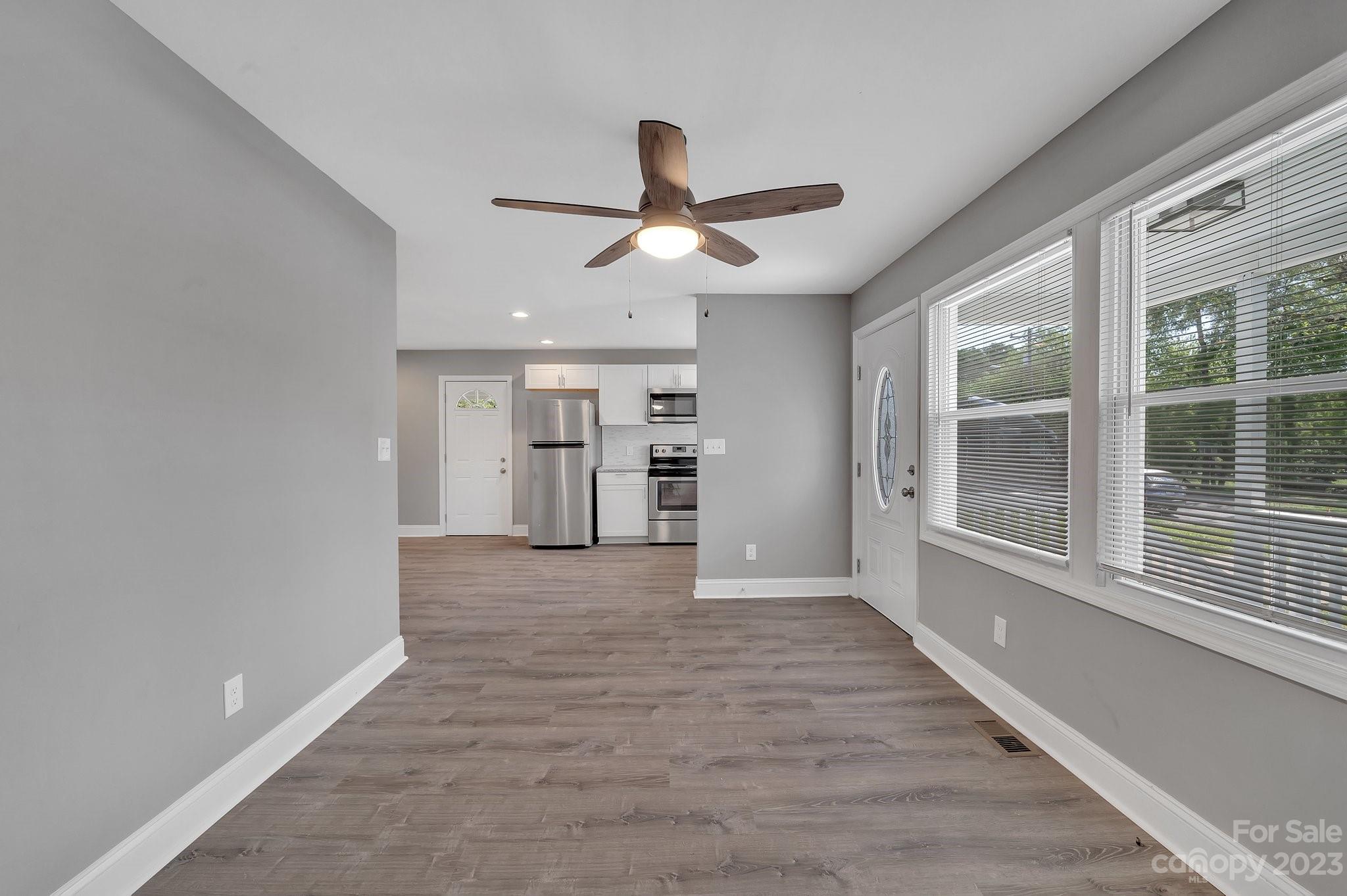 128 Jeter Street Chester, SC 29706 - Photo 4 of 20 a view of an empty room with a window and kitchen view