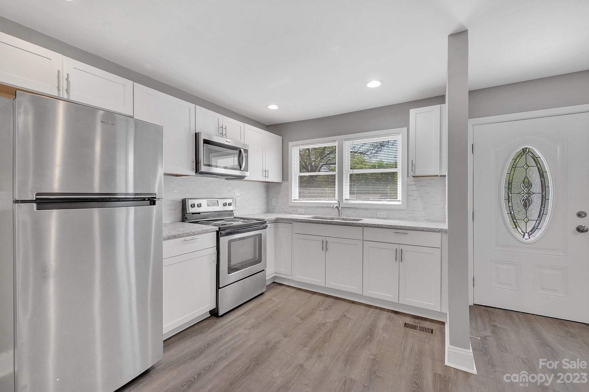 128 Jeter Street Chester, SC 29706 - Photo 5 of 20 a kitchen with stainless steel appliances granite countertop a refrigerator sink and stove