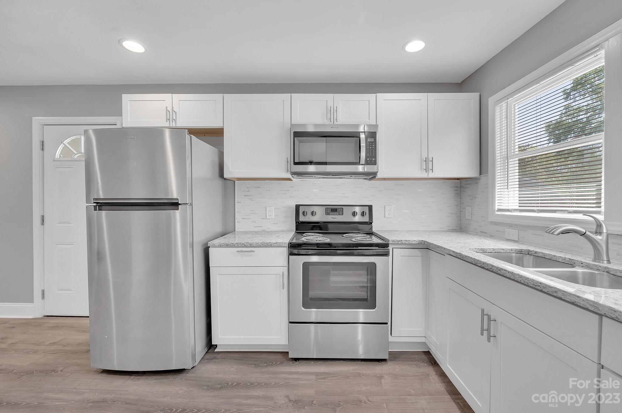 128 Jeter Street Chester, SC 29706 - Photo 7 of 20 a kitchen with cabinets stainless steel appliances a sink and a window