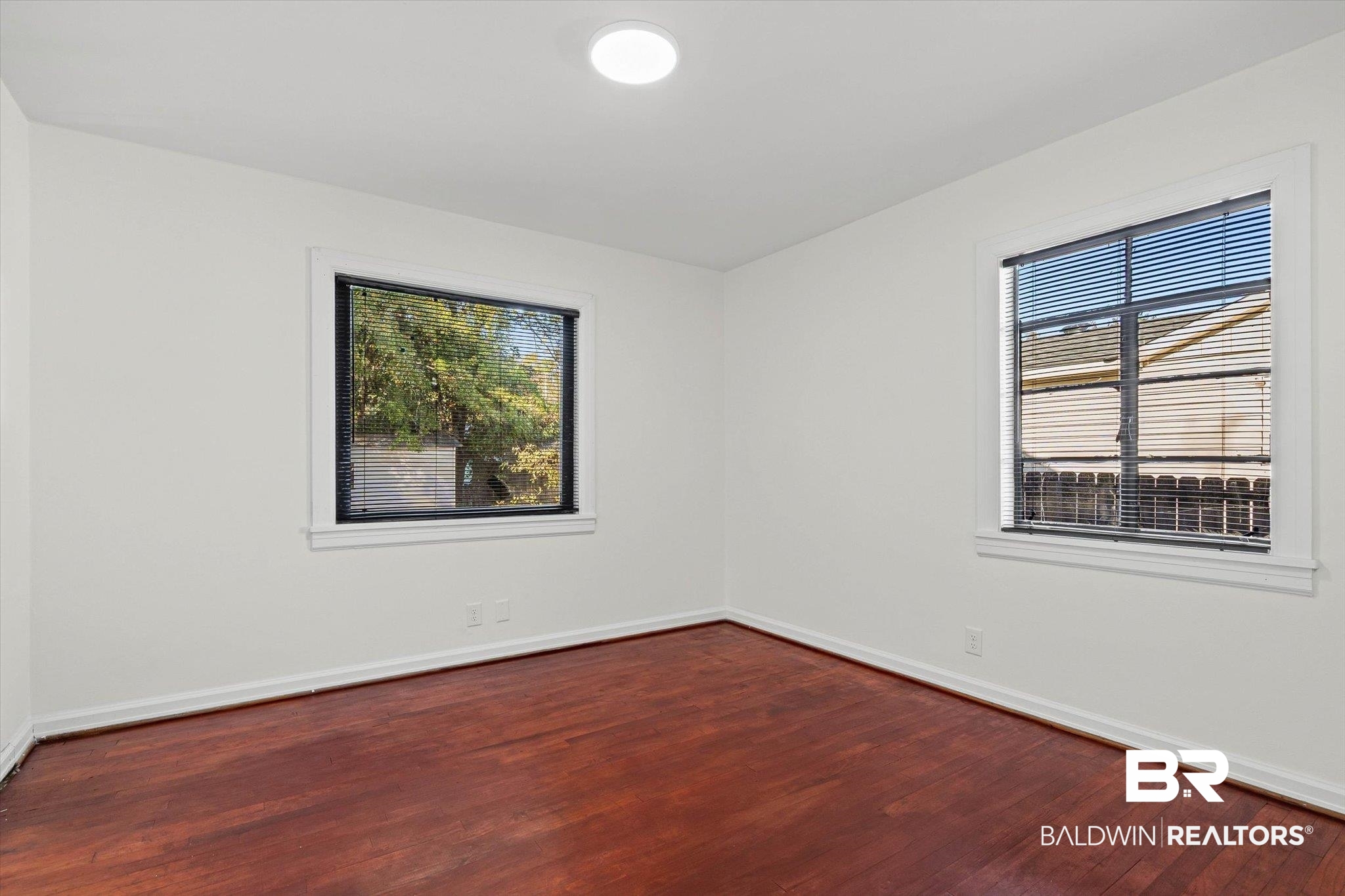 2806 Exter Drive Mobile, AL 36606 - Photo 13 of 24 Spare room featuring dark wood-style flooring and plenty of natural light